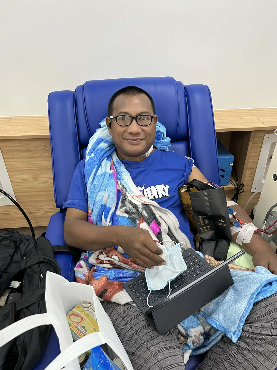 TresMedica staff handing a community basket to a patient