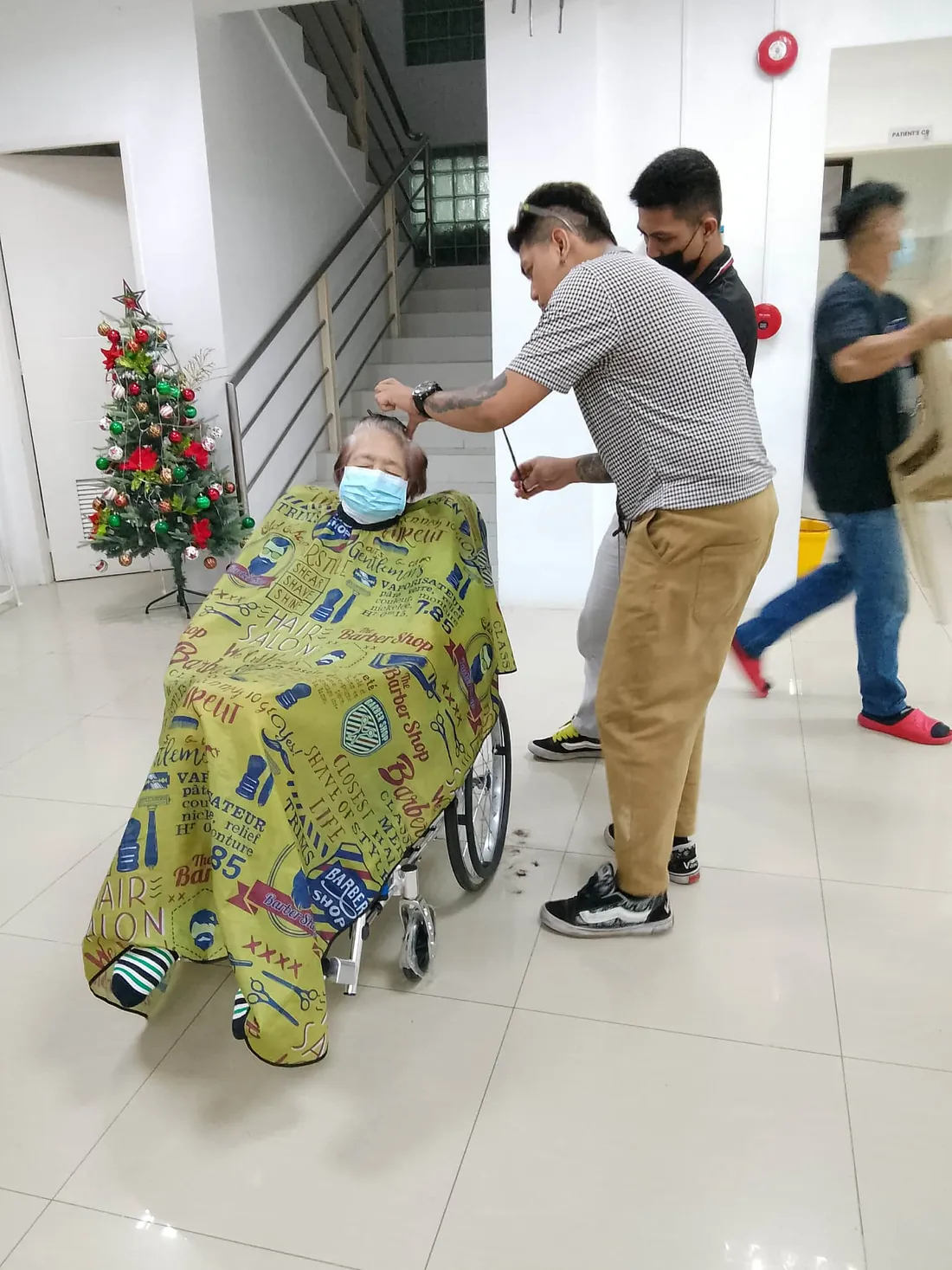 A barber grooming a dialysis patient